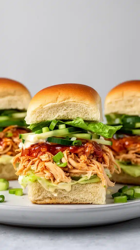 Delicious Bang Bang Chicken Sliders garnished with fresh ingredients